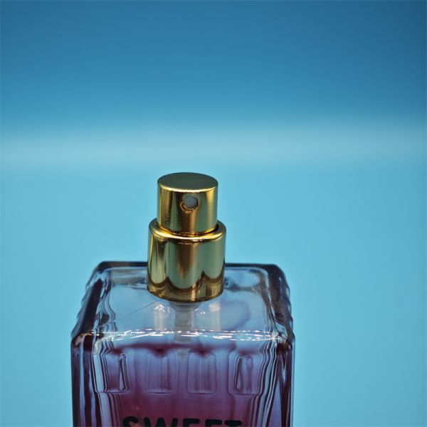 Close-up of logo engraving on perfume spray pump